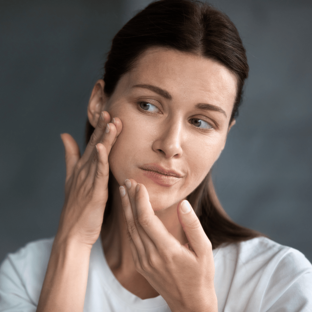 woman looking at skin on face