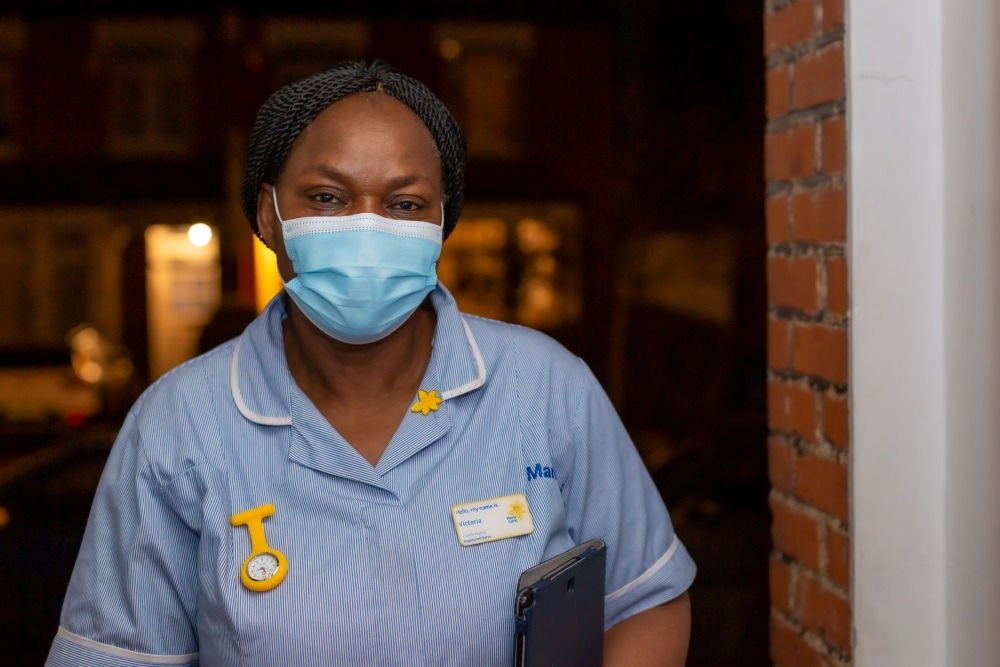 nurse at front door in the dark
