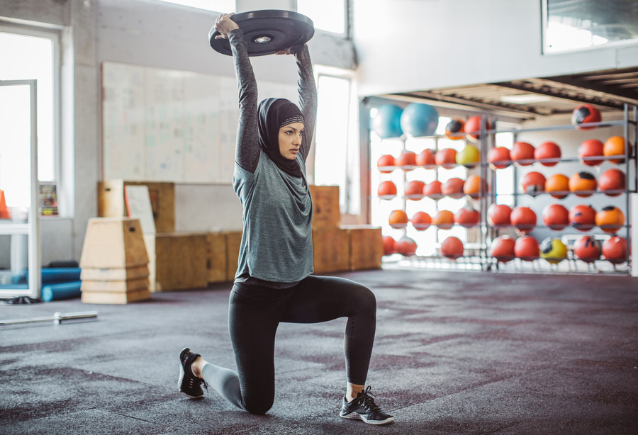 Woman lifting weight above head