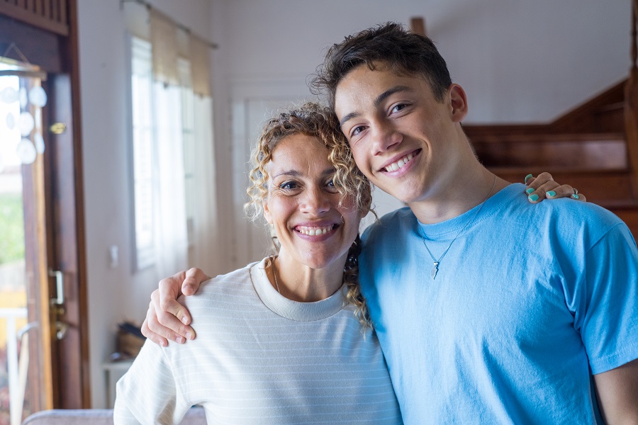 Mum and son smile at the camera