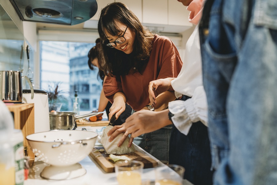 Students cook together in kitchen