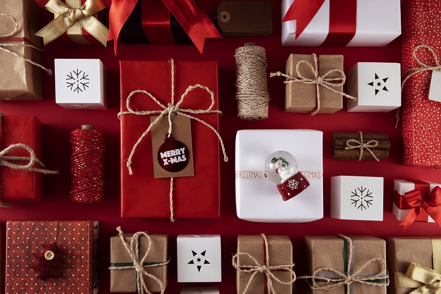 Multiple Christmas gifts wrapped up in red, gold and white paper