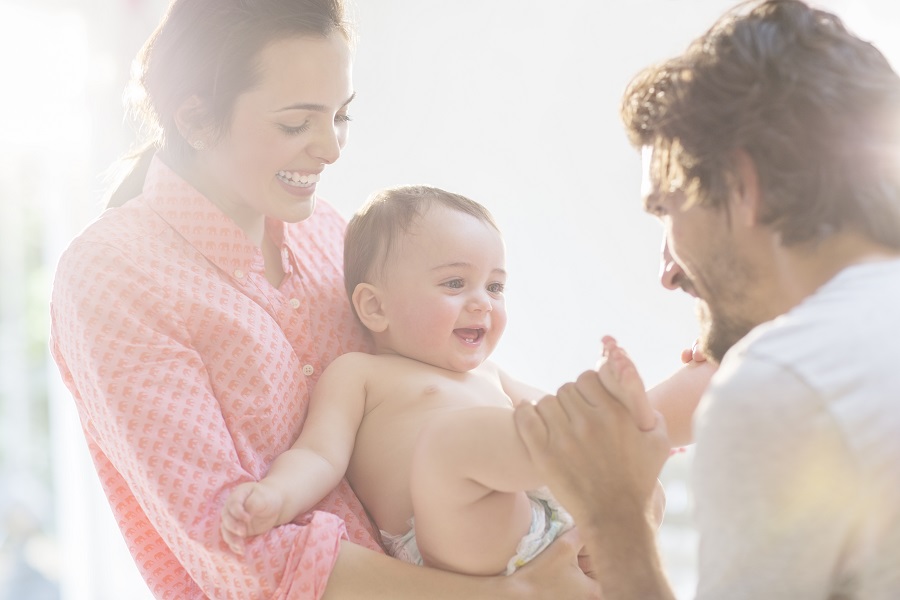 Parents play with baby