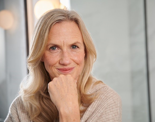 mature blonde woman smiling at camera. 