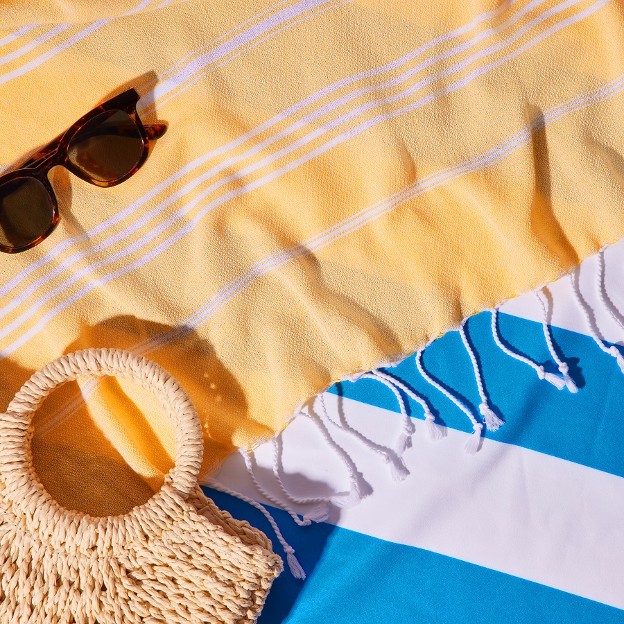 bag and sunglasses on beach towel 