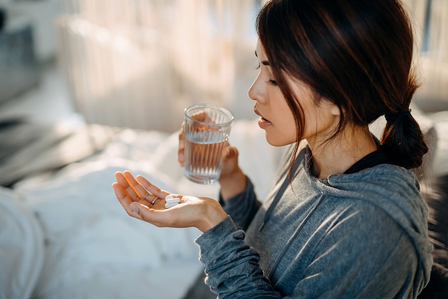 woman taking medication with water 