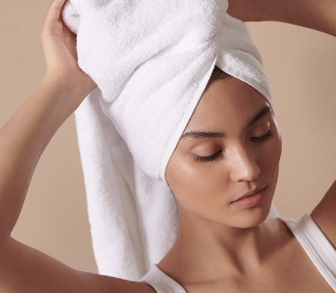 woman drying her hair with a towel