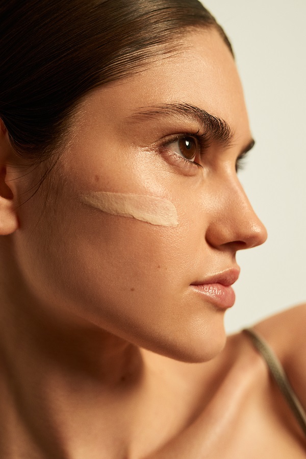 foundation streak on cheek of model