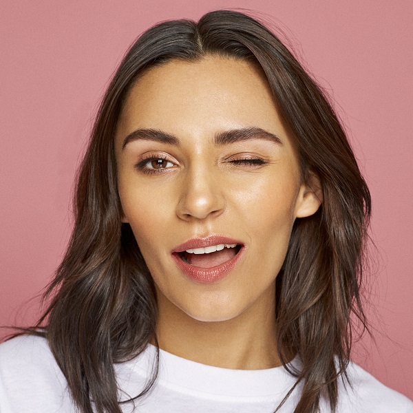 woman wearing makeup winking at camera 