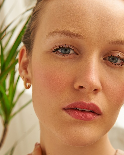 model with red blush and lipstick