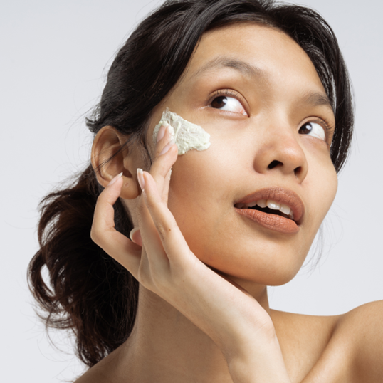 a lady applying face cream