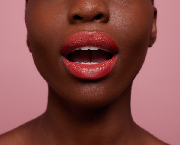 close up shot of model opening mouth with bright red lipstick 